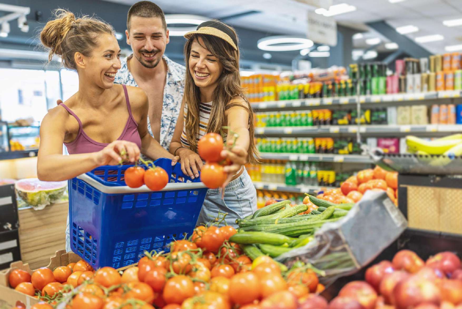 Friends picking tomatoes in the produce section